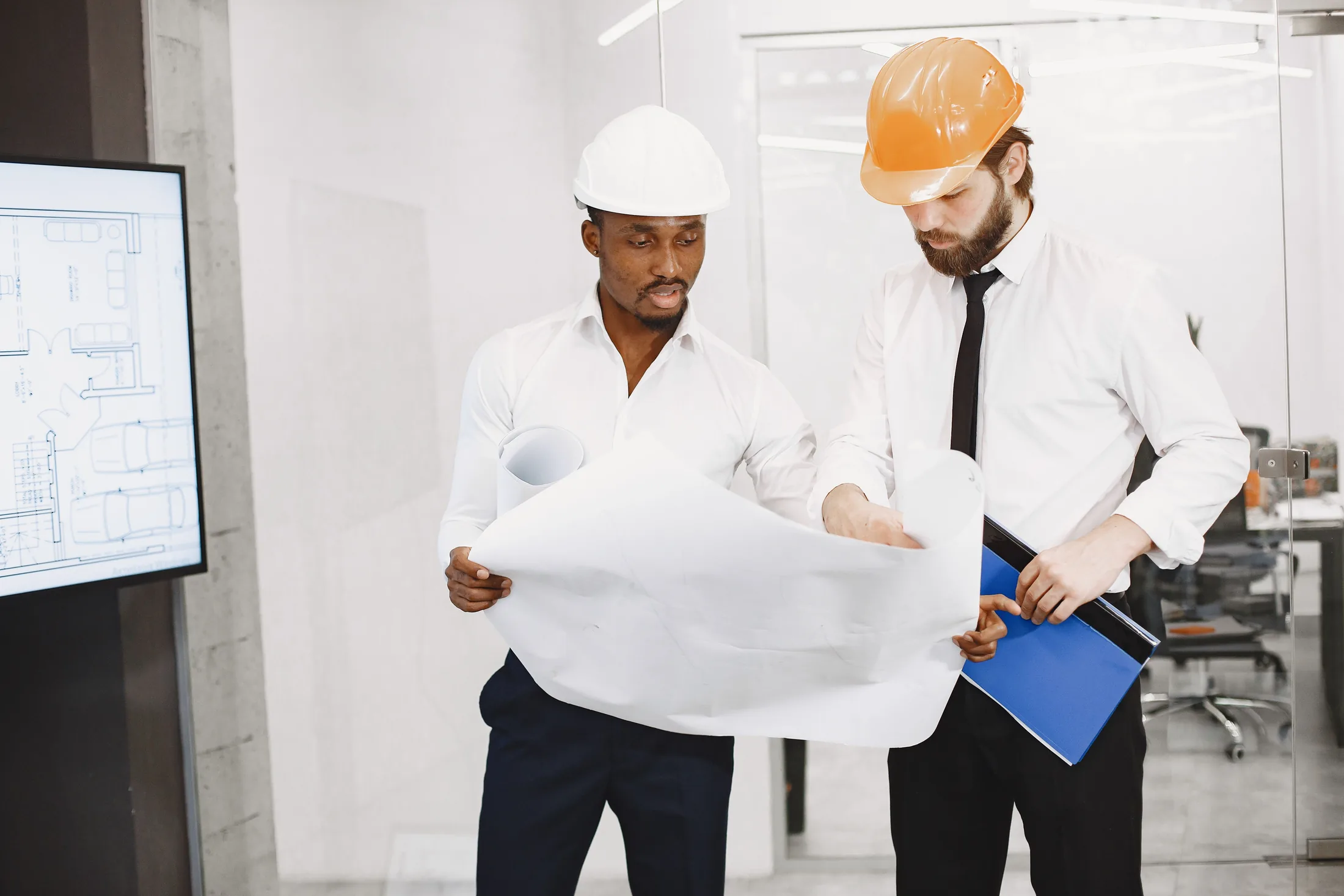Architect and engineer reviewing house construction blueprints